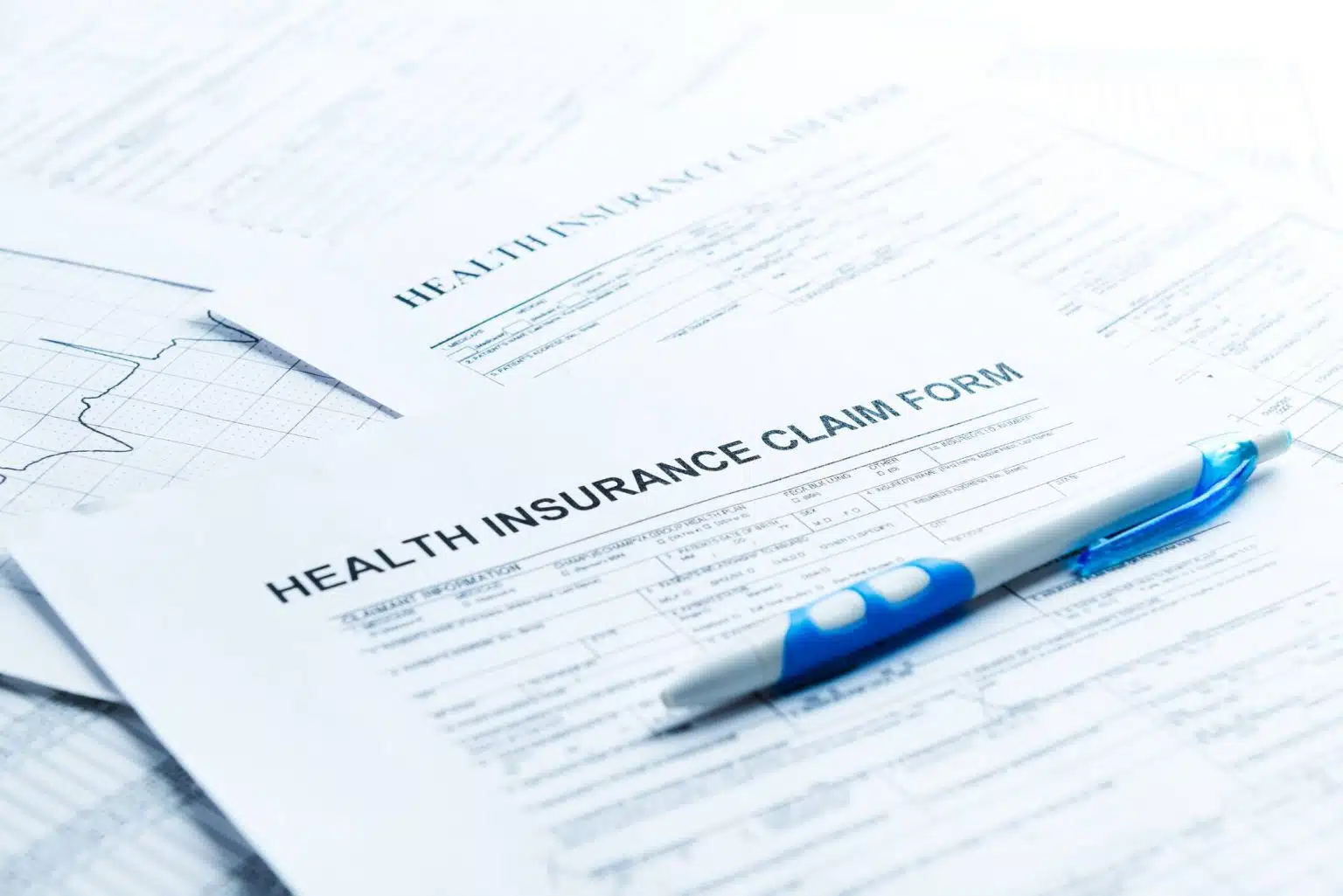 Health insurance claim form with pen on top.