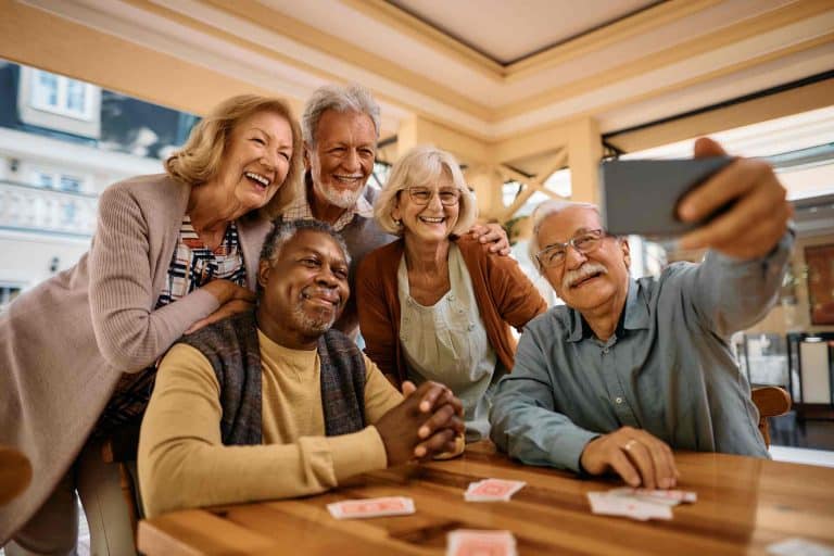 Group of elderly friends smiling for a selfie