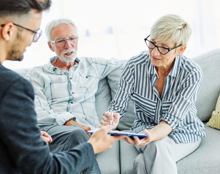 Mature couple looking over Medicare coverage options.