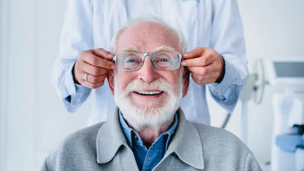 Smiling, mature man getting fitted for new glasses